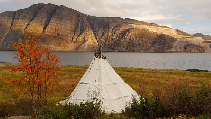Sami tent in open nature, mountain in the background