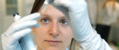 Close-up of researcher looking into a test tube