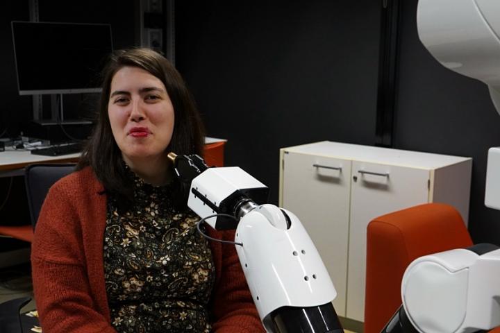 The robot has put lipstick on the researcher.