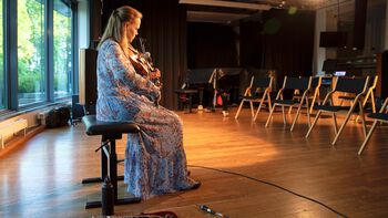 Scandinavian fiddle music was one musical genre in the comparative design of the TIME project. Here fiddler Anne Hytta performs at the Rhythm Production and Perception Conference in 2021. Hytta was also interviewed as an informant on sound-timing interactions in the fiddle genre.