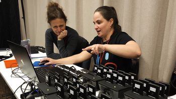Sara D&#39;Amario and Kayla Burnim check that all 70 physiological measurement devices are ready to be handed out to musicians.
