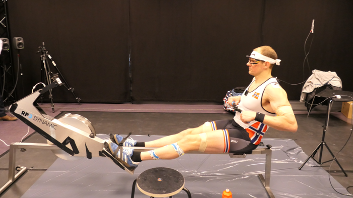 Man sitting on rowing machine in the motion capture lab